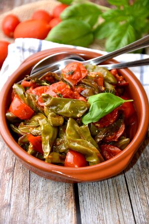 fried green peppers with tomato and basilの写真素材