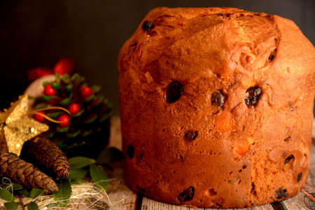 traditional Italian sweet panettone for Christmas holidays on black background and Christmas decorationsの写真素材