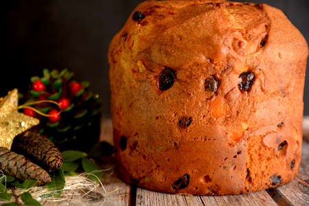 traditional Italian sweet panettone for Christmas holidays on black background and Christmas decorationsの写真素材