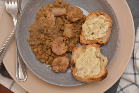 lentil dish with pork sausage and bread croutons with mushroom cream typical Italian foodの写真素材