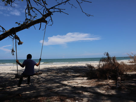 Playing swing on the beachの写真素材
