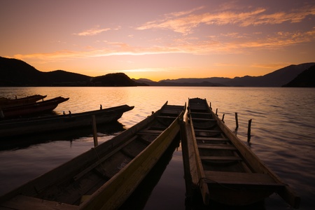 wooden boats in the Lugu lake Lugu lake in the dawn in Yunnan,Chinaの写真素材