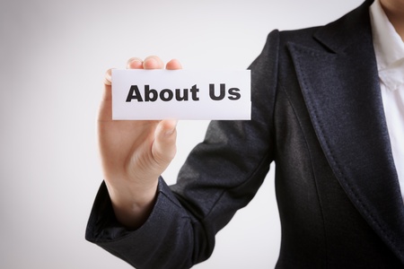 business woman with a paper card with about us words on itの写真素材