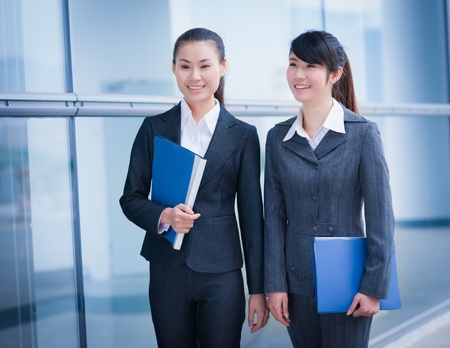 business women with folders in the officeの写真素材