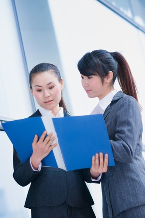 business women talking about business plan with foldersの写真素材