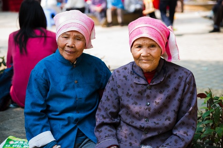 Nanning, China - March 24, 2012: two Chinese senior woman with traditonal dress looking at the cameraのeditorial素材