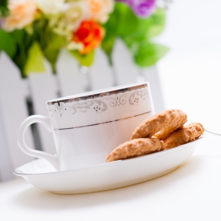 a cup of coffee and biscuit on white backgroundの写真素材