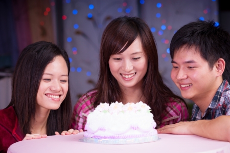 young asian friends at birthday partyの写真素材