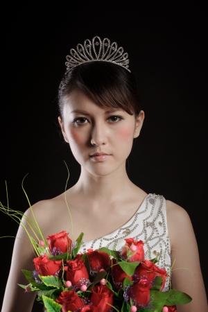 Chinese bride with flowers in photo studioの写真素材