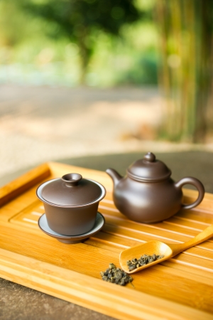 teapot and teacup on a bamboo matの写真素材
