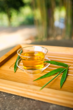 teapot and teacup on a bamboo matの写真素材