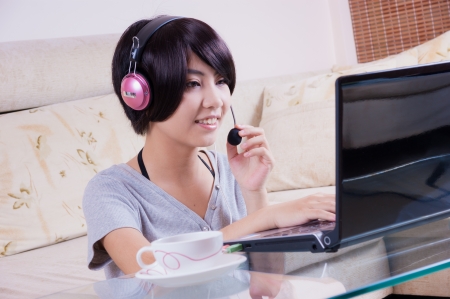 young asian girl chatting with laptopの写真素材