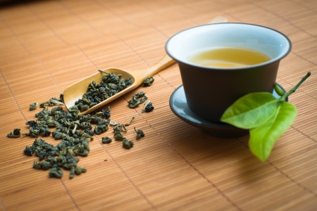 tealeaves and teacup on the bamboo matの写真素材