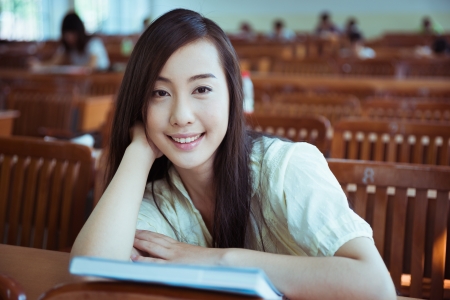 smiling Chinese female college student in the classroomの写真素材