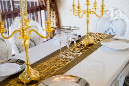 nice tableware and candlesticks on dining tableの写真素材