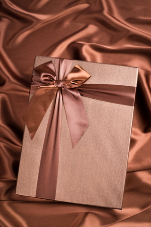 very nice gift box on silk cloth with chocolate colorの写真素材