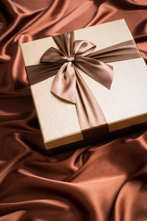 very nice gift box on silk cloth with chocolate colorの写真素材