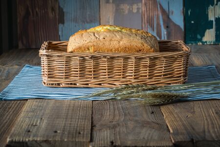bread and ear of wheat on a tableの写真素材