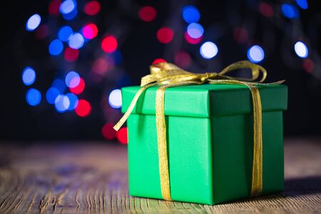 nice present box on vintage wood plank with bokeh of light backgroundの写真素材