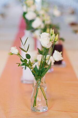 White eustoma flowers in glass transparent vase in wedding or Banquet table decorの写真素材