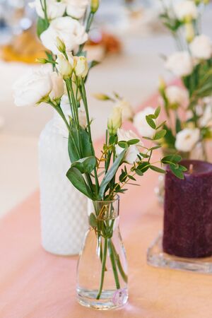 White eustoma flowers in glass transparent vase in wedding or Banquet table decorの写真素材