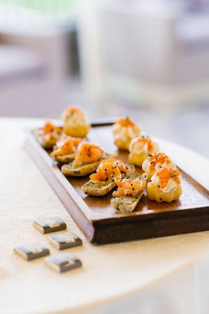 Snacks with red fish on the buffet tableの写真素材