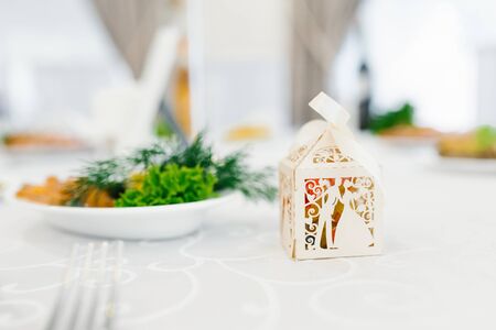 Beige paper box bonbonniere at the wedding is on the tableの写真素材