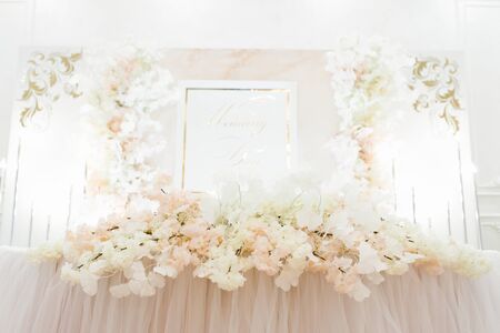 Floral arrangement on the Banquet table of the bride and groom at the weddingの写真素材