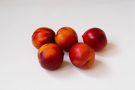 organic fresh nectarines on white backgroundの写真素材