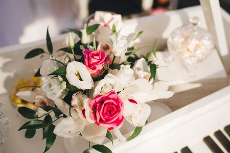 Wedding flower arrangement of white eustoma, Orchid and pink roses in the wedding decorの写真素材
