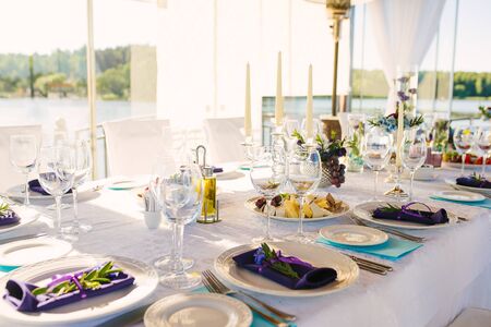 Banquet table with wedding and festive serving in white blue and purple colorsの写真素材