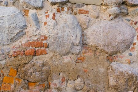 Stone and brick old masonry wall, background to copy spaceの写真素材