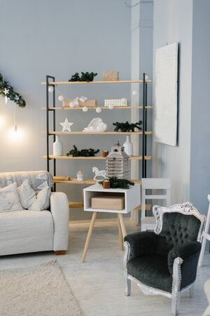 The interior of the living room or study, decorated for Christmas or new year, shelving or shelf and chairの写真素材
