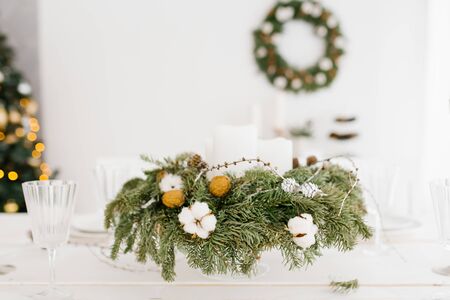 Christmas composition of spruce, cotton, walnut on the holiday tableの写真素材