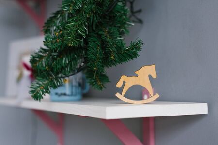 Wooden toy horse made of plywood is on the shelf in the roomの写真素材