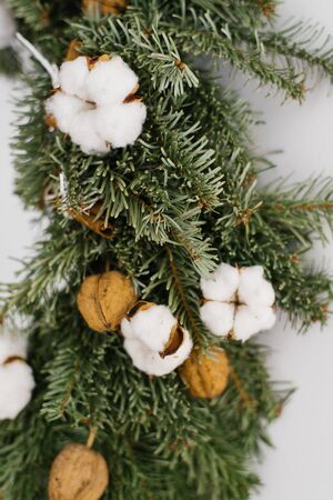 Part of the Christmas wreath close-up: spruce, cotton and walnutsの写真素材