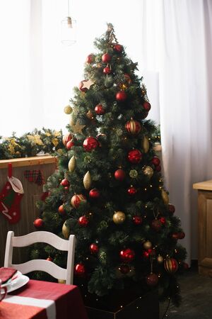 Christmas tree stands at the window in the dining room or living roomの写真素材