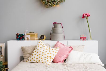 Bed with white and pink pillows, decorated for Christmas and New Yearの写真素材