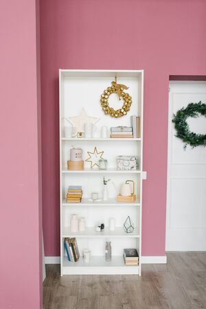 Shelf with Christmas decor in a pink colored living room and hallway in the houseの写真素材