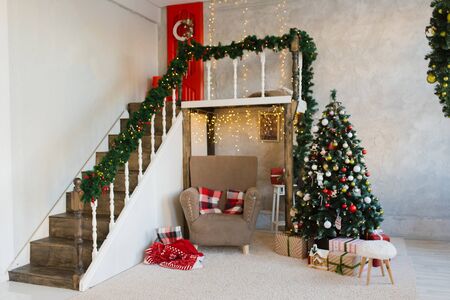 Traditional living room with a Christmas tree in red and white colorsの写真素材