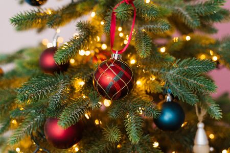 Red and blue christmas tree toys with lights, close-upの写真素材