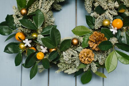 Closeup of a piece of christmas wreath on a wallの写真素材
