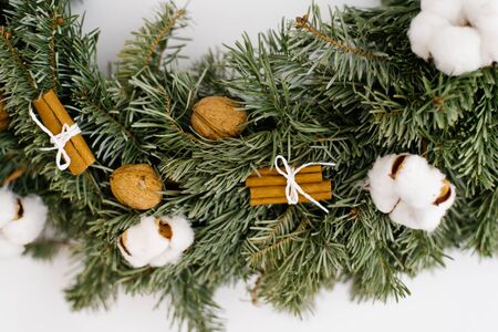 Closeup of a piece of christmas wreath on a wallの写真素材