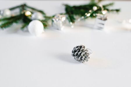 Silver cone on the background of holiday lights and decorations with copy space. Greeting card for the new Yearの写真素材