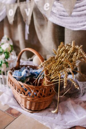 Ears of wheat in a wicker basket. National decor of Belarusの写真素材