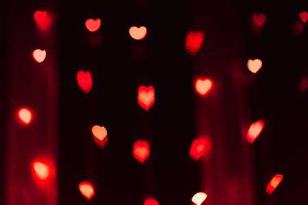 Red and pink highlights or bokeh in the form of hearts, traces of lights out of focus. Festive...