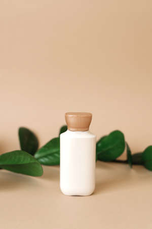 Natural cosmetic cream for beauty, skin care. an empty bottle with grass leaves in the background. bio organic product.の写真素材