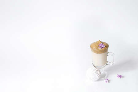 Dalgon's trending drink is coffee. Coffee mug, lilac and marshmallow on a white background. Copying spaceの写真素材