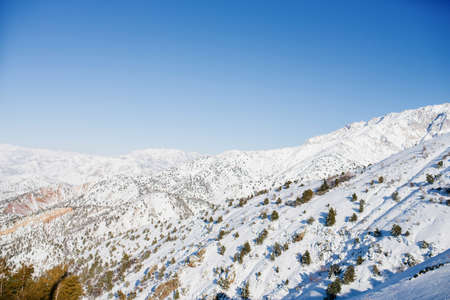 Tien Shan mountains covered with snow in Uzbekistan on a clear day. Beldersay ski resortの写真素材
