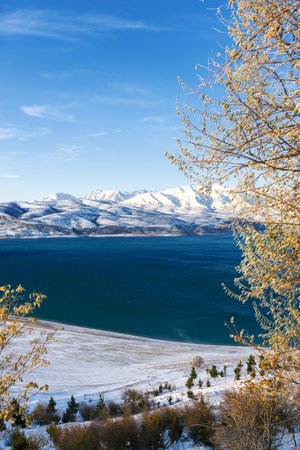 Charvak mountain lake in Uzbekistan on a snowy frosty day, surrounded by the Tien Shan mountainsの写真素材